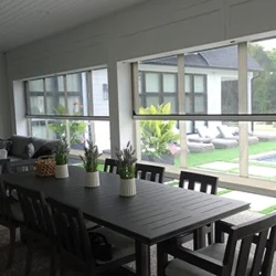 Combo retractable patio screens with clear vinyl and mesh layers installed on an outdoor living area