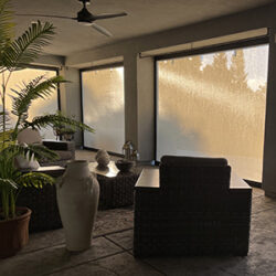 Retractable patio screens with mesh installed on a covered porch for insect protection and airflow
